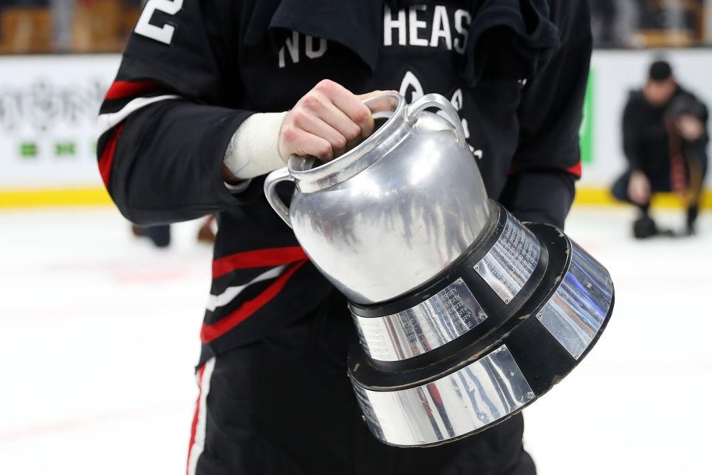 A Northeastern player holds the Beanpot trophy after winning the 2019 tournament in 2019