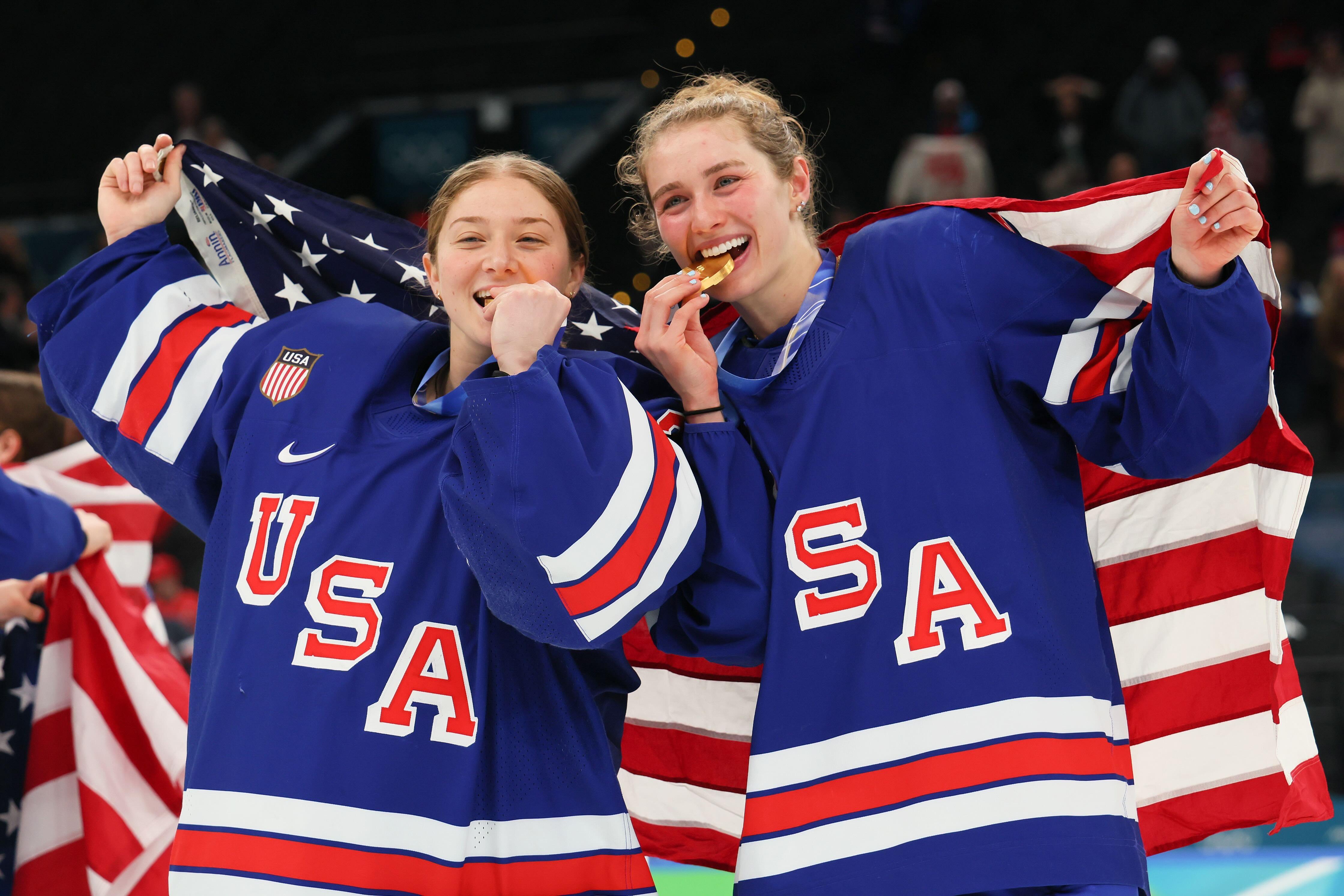 Olympic MVP Caroline Harvey celebrates winning the gold medal with goaltender Aerin Frankel